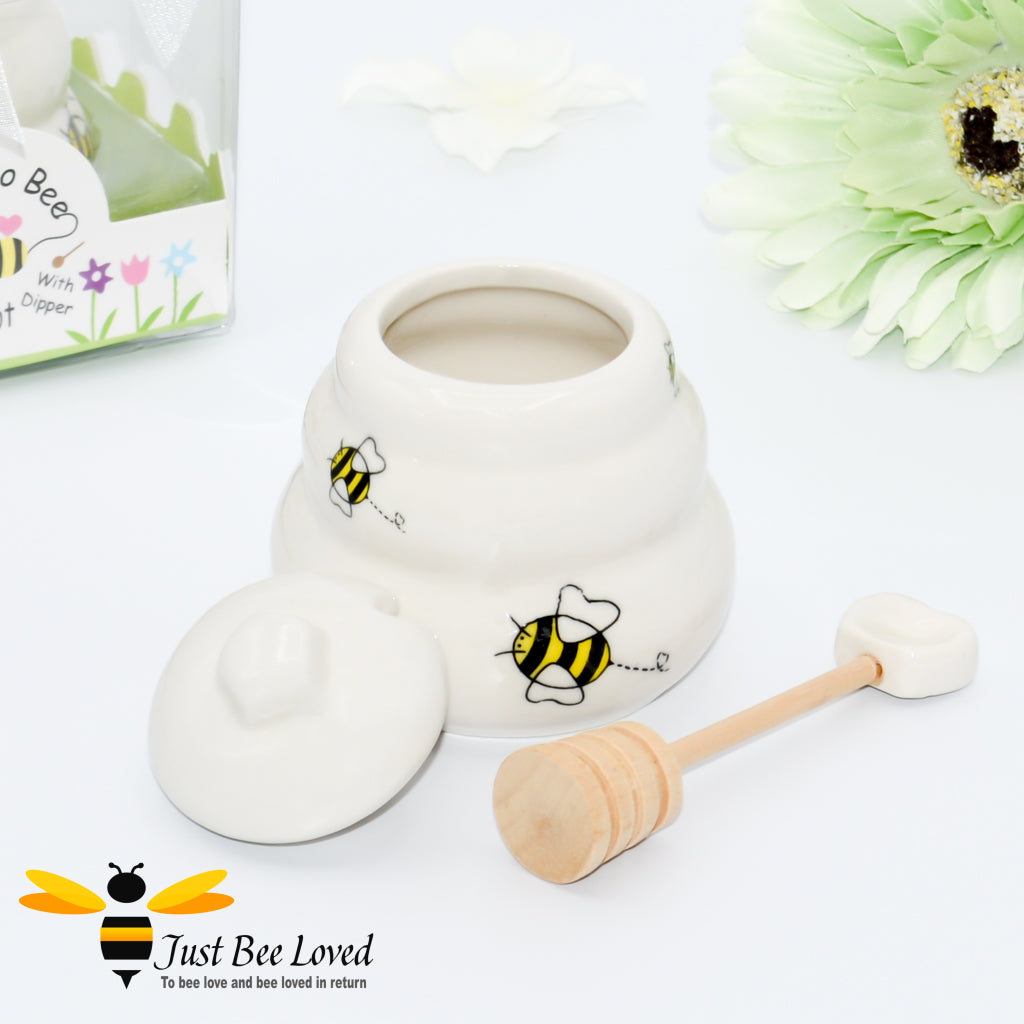 Ceramic hive shaped honey pot with dipper, decorated with bees in a gift box with 'meant to bee' text.