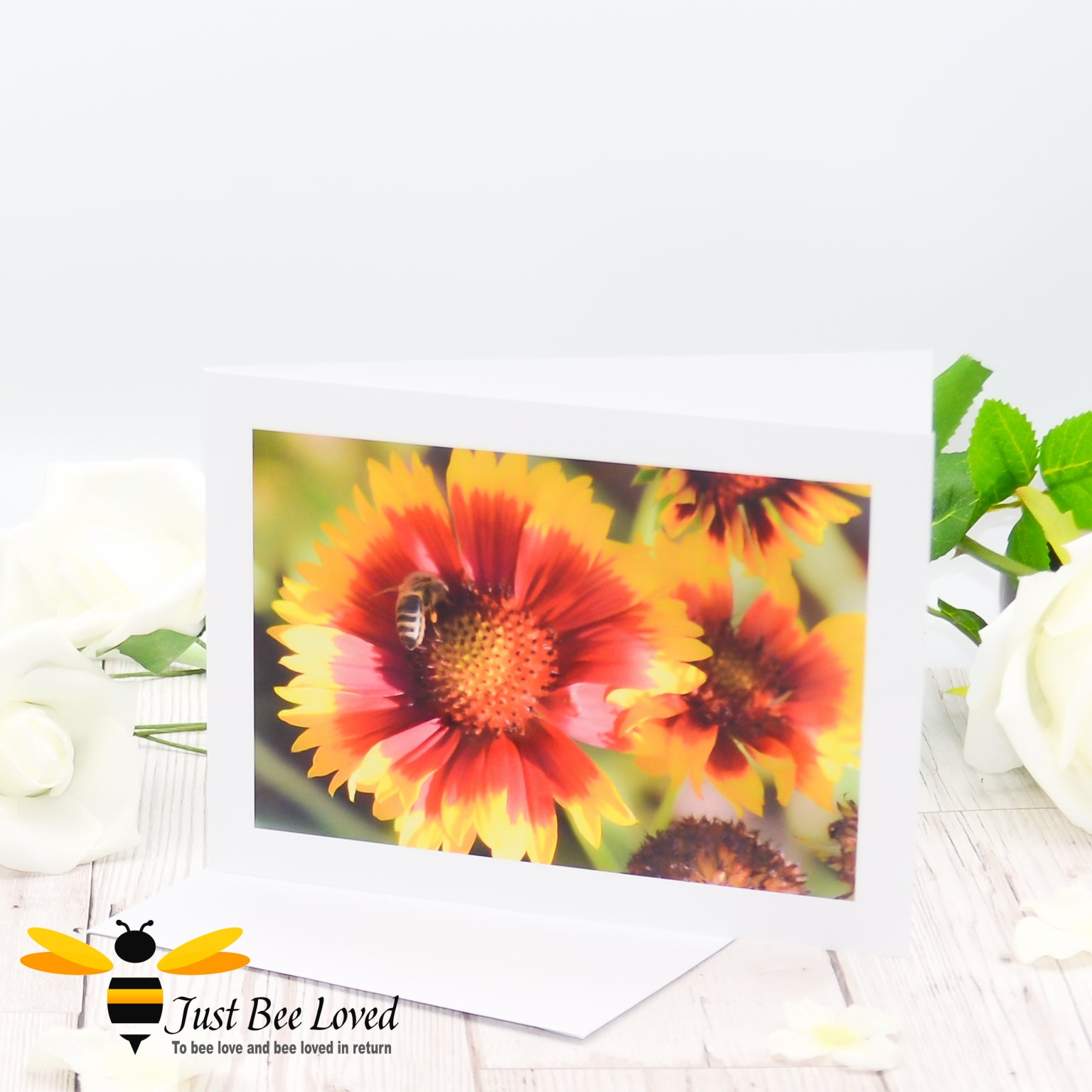 A photographic greeting card featuring an image of a honey bee collecting pollen from orange flowers.  Card is blank for a personal message.