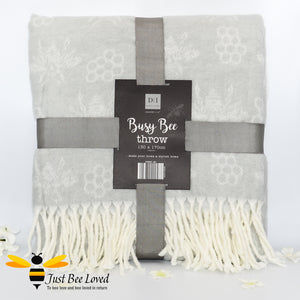 acrylic woollen throw blanket in grey featuring an all over honey bee & honeycomb design with fringe border