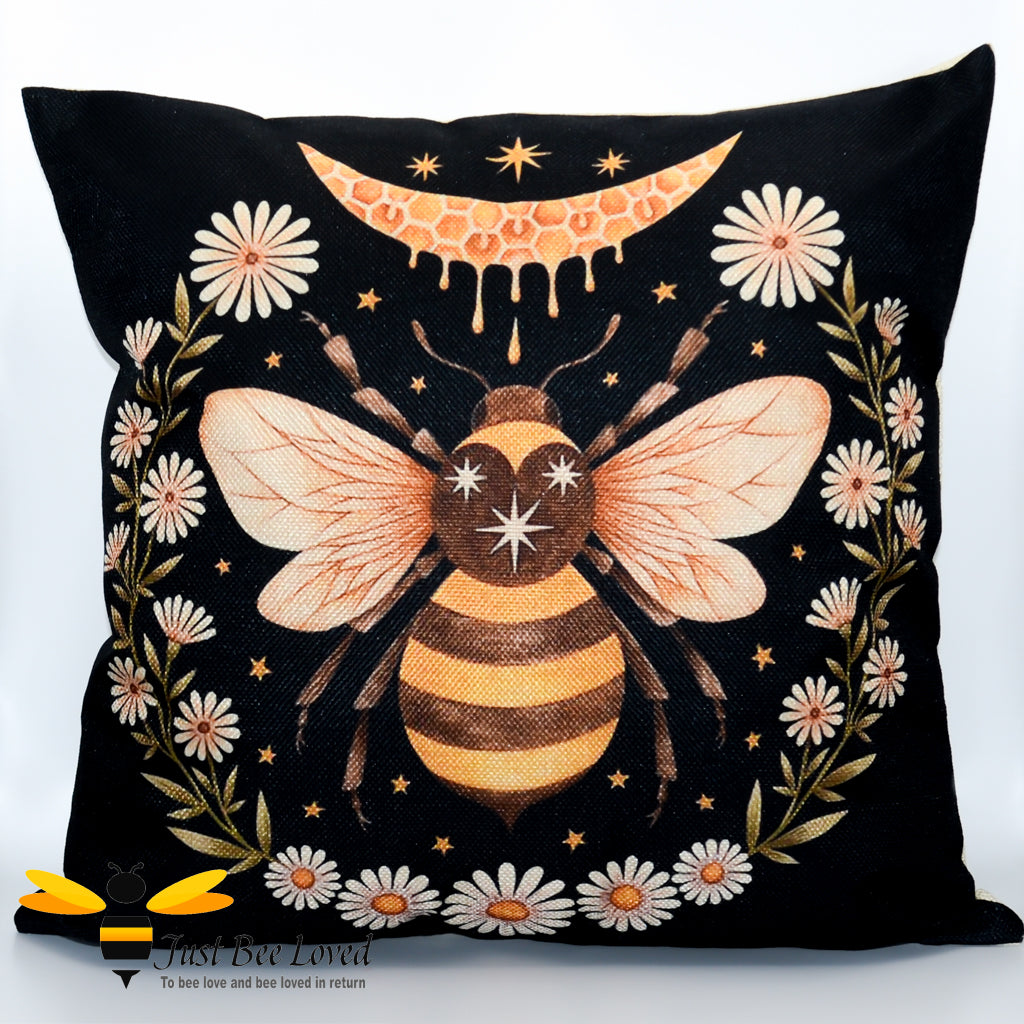 Black cushion featuring a honey dripping crescent moon with a honeybee surrounded by daisy flowers.