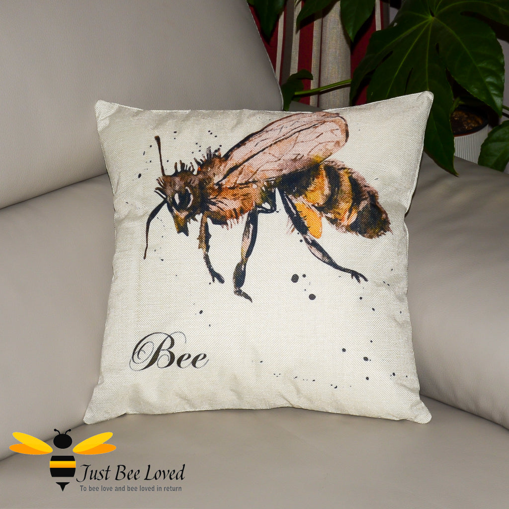 Natural coloured scatter cushion featuring a watercolour image of a bee on a splashed background with "Bee" calligraphy.
