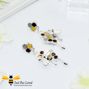 silver plated earrings each featuring honey drips, enamelled filled honeycomb to look like pollen with a honeybee.  