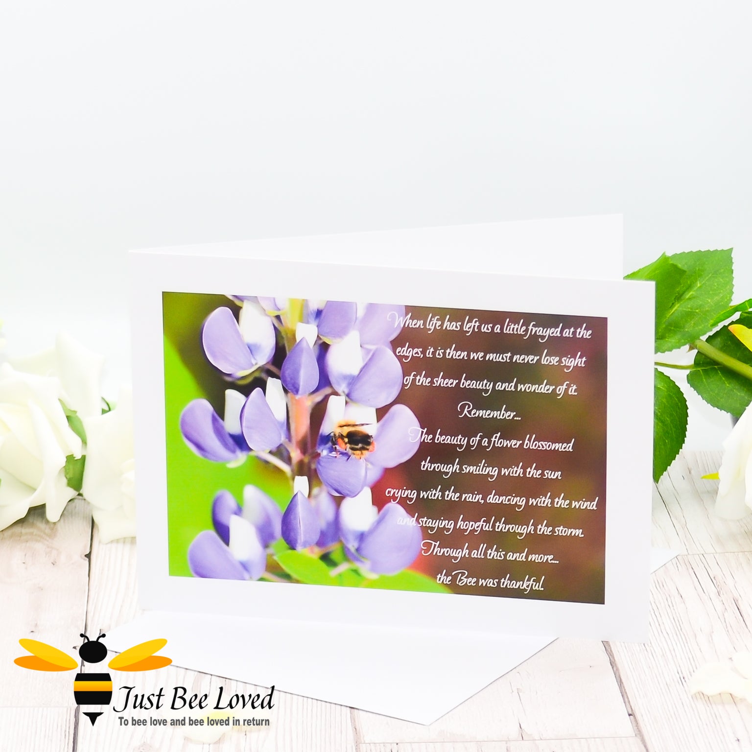 a greeting card showing a landscape photographic print of a wild bee foraging on purple lupine flowers with an accompanying inspirational verse.