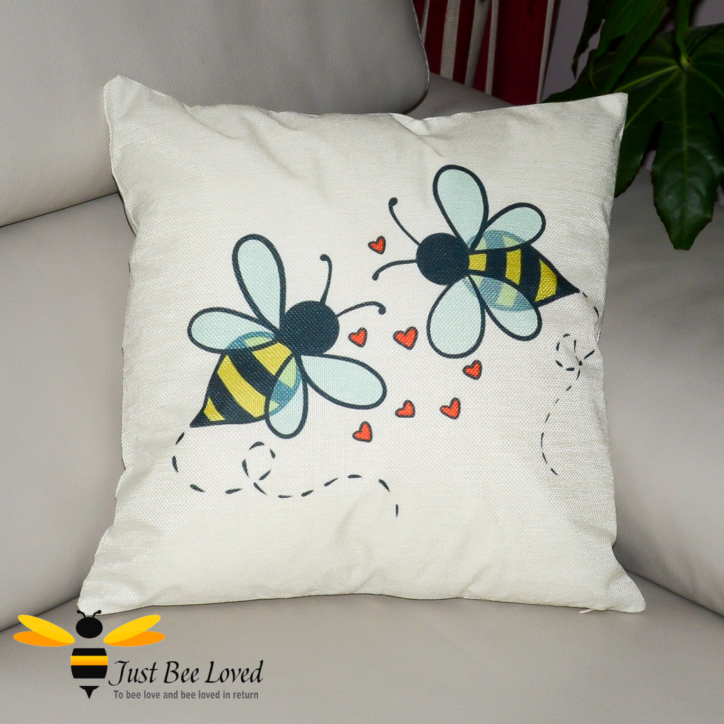 cream cushion featuring two bumblebees with love-hearts