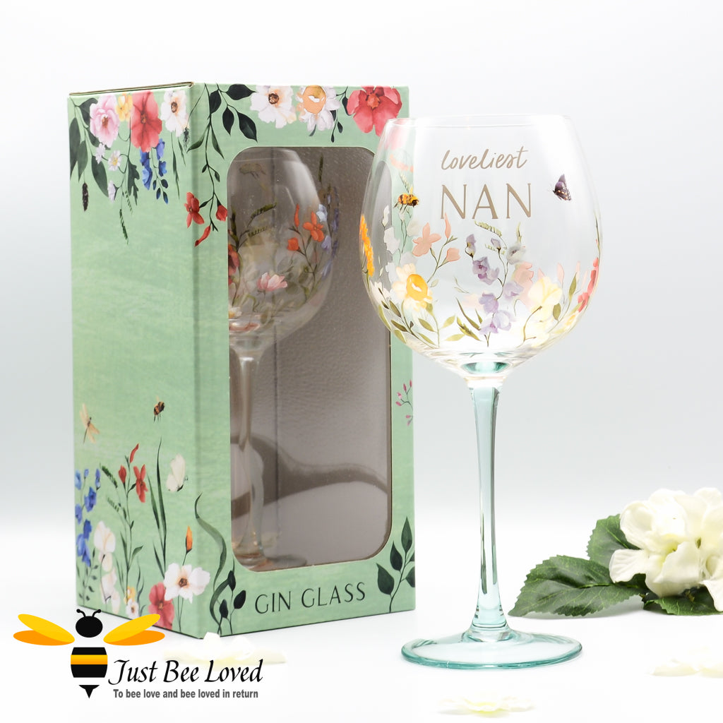 A gift boxed stemmed gin glass with bees, butterfly and floral design with 'Loveliest NAN' text.