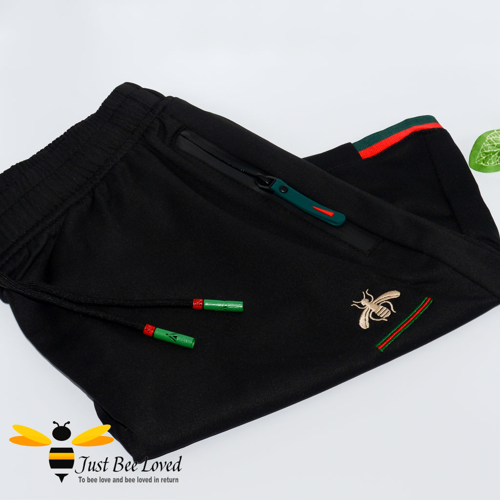 2-piece black t-shirt and shorts embroidered with a gold bee and colour coordinating red & green stripes.