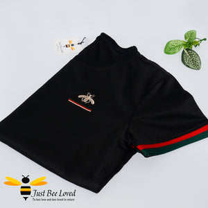 2-piece black t-shirt and shorts embroidered with a gold bee and colour coordinating red & green stripes.