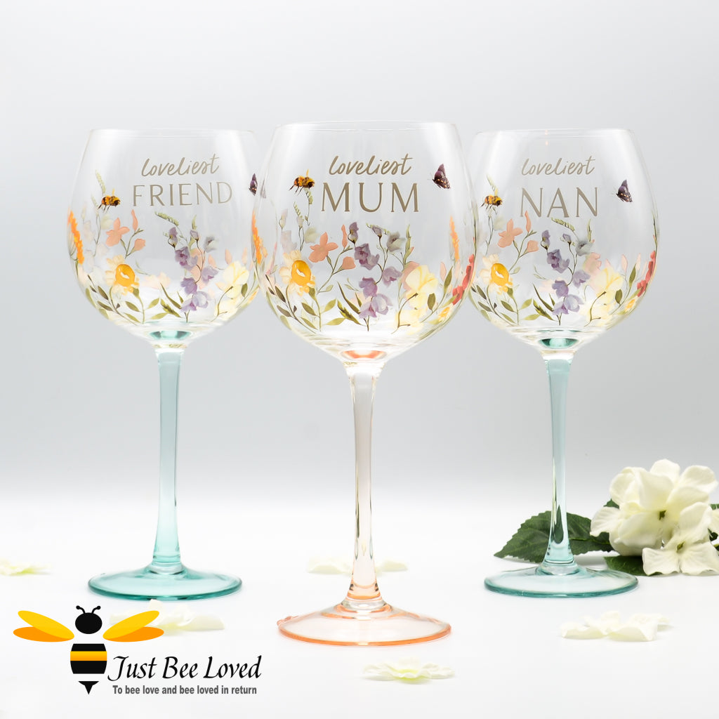 A set of three stemmed balloon gin glasses with floral and bee design, each labelled: 'Loveliest MUM', 'Loveliest NAN', and 'Loveliest FRIEND'.