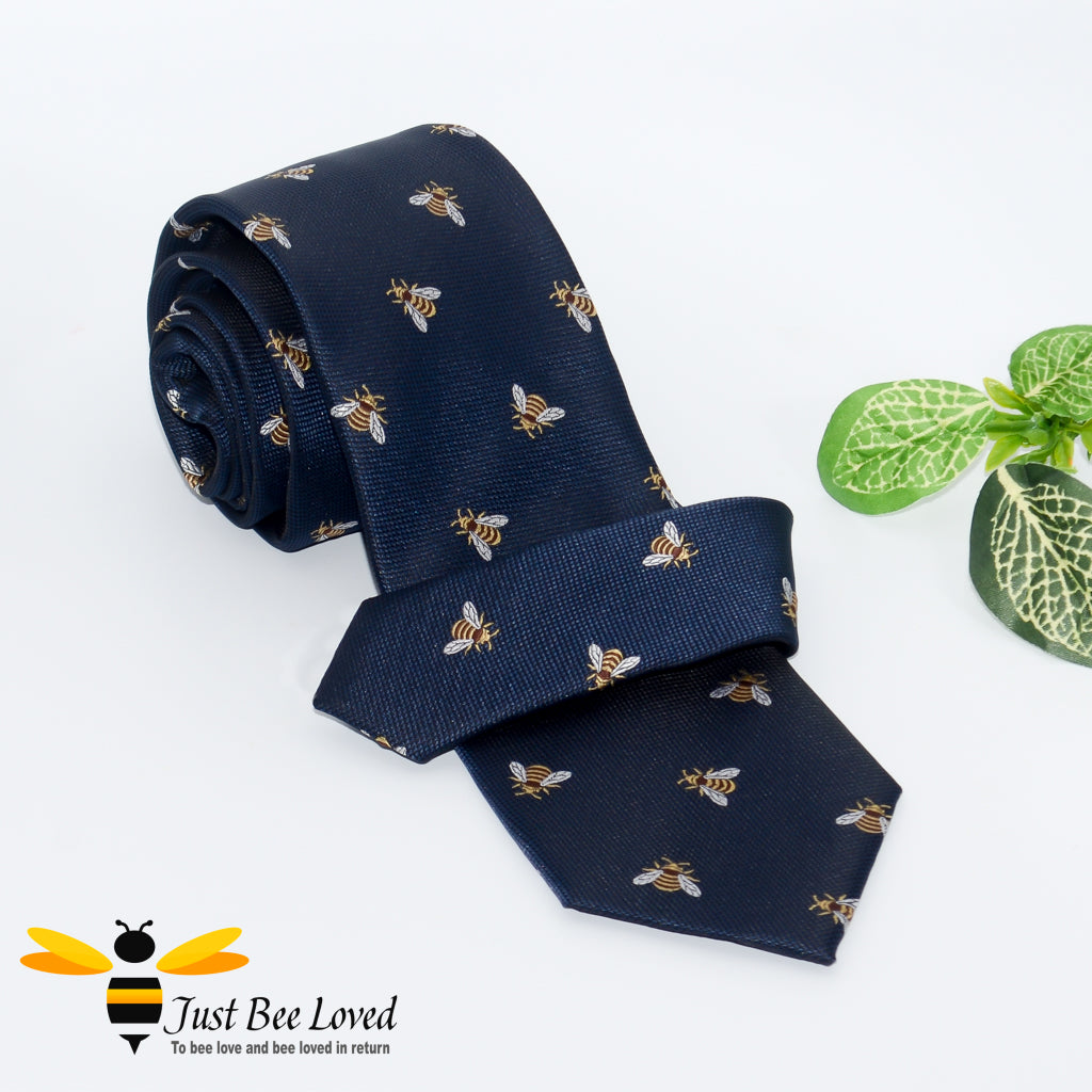 Handmade woven navy blue necktie featuring an all over embroidery design of bumblebees