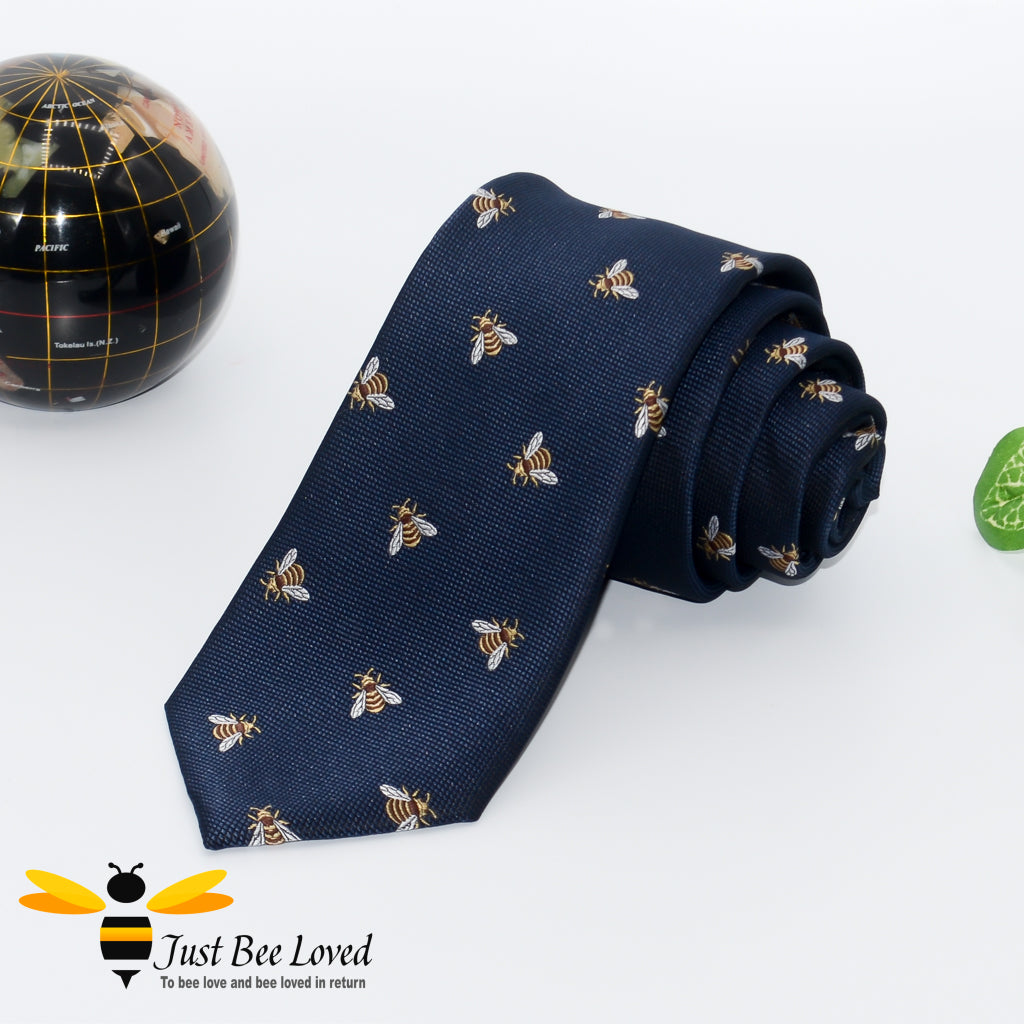 Handmade woven navy blue necktie featuring an all over embroidery design of bumblebees