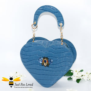 Deep blue faux patent leather heart-shaped handbag featuring embossed crocodile skin, detailed with a handmade crystal bee at its centre