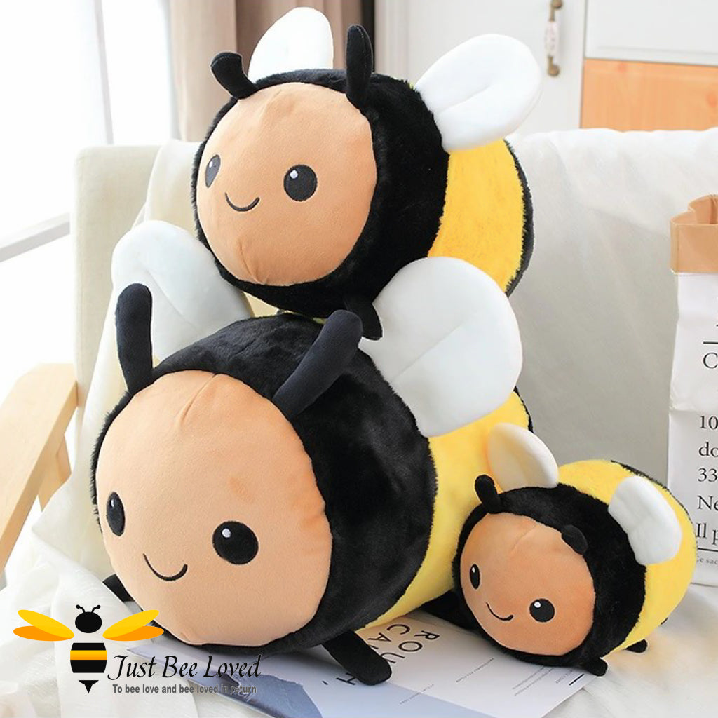 A cuddly bumble bee plush soft toy, with multiple sizes displayed, designed to look like a bee with black and yellow colouring and cute facial features.