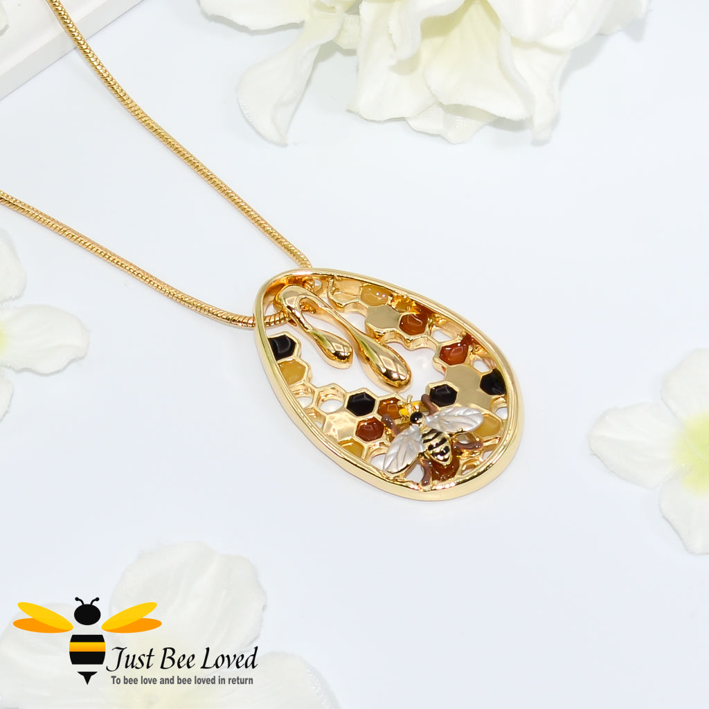 gold plated pendant necklaces each featuring golden honey drips, enamelled filled honeycomb to look like pollen with a honeybee.  