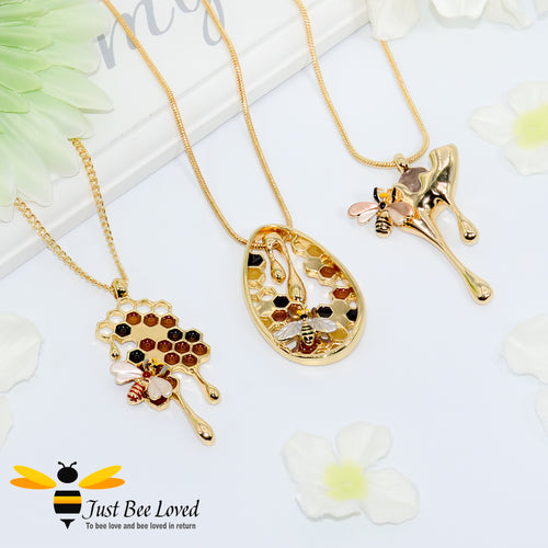 gold plated pendant necklaces each featuring golden honey drips, enamelled filled honeycomb to look like pollen with a honeybee.  
