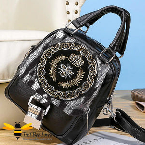 bag featuring a crystal embellished Queen Bee frontal design on black & silver snake print