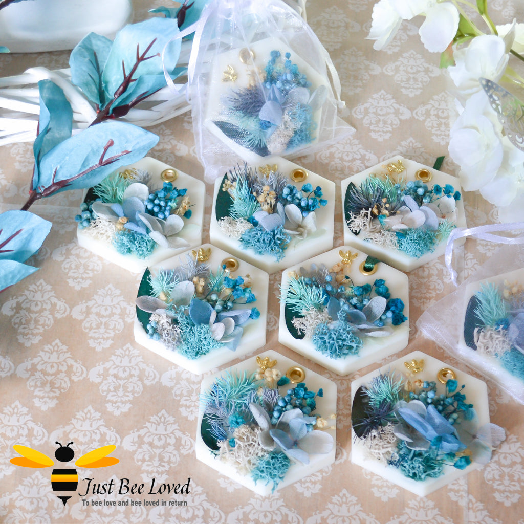 display of scented botanical vegan wax tablets decorated with blue natural flowers, gold bee, fragrance hazelnut & winter woodland