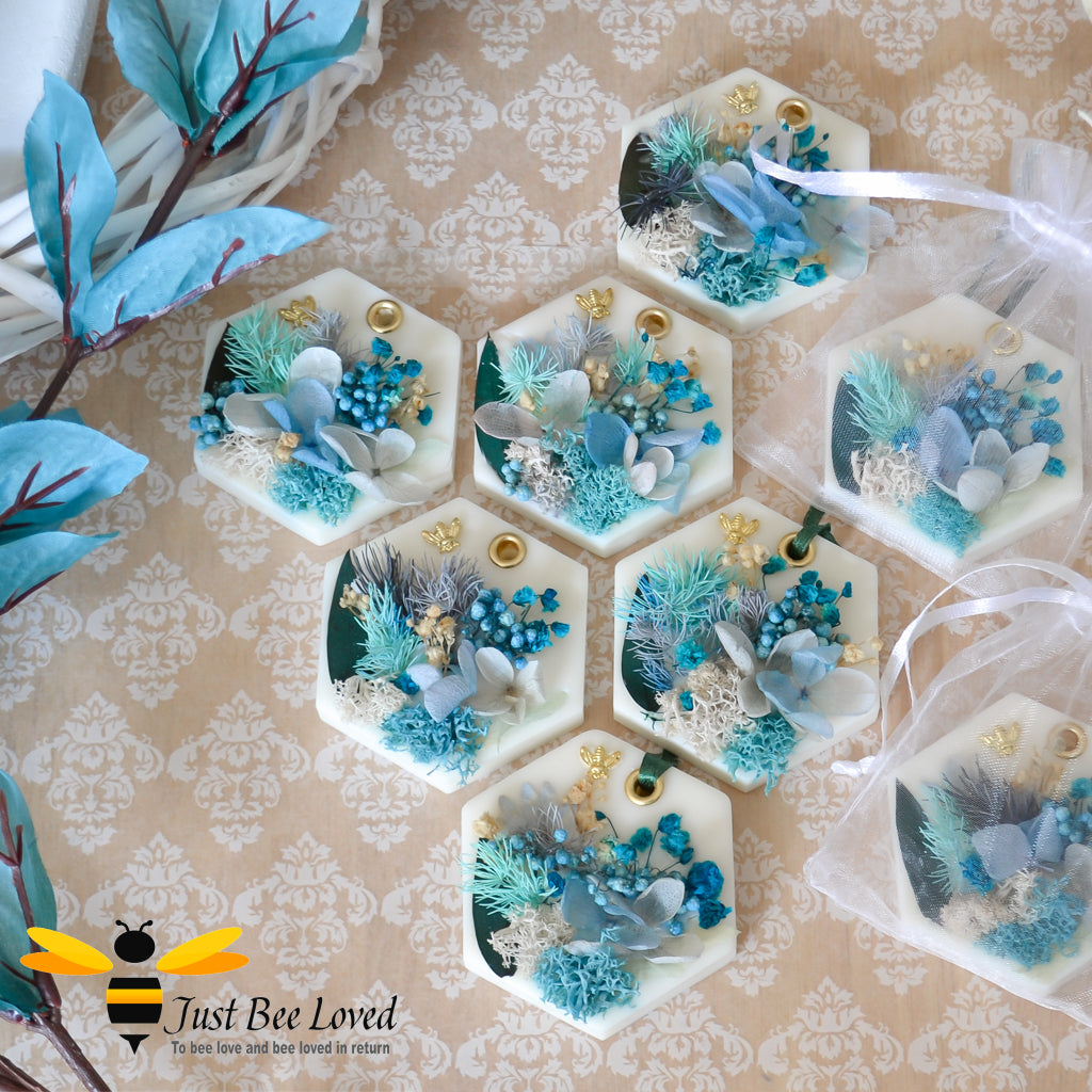 display of scented botanical vegan wax tablets decorated with blue natural flowers, gold bee, fragrance hazelnut & winter woodland