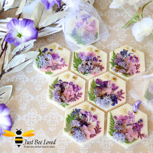 display of scented botanical vegan wax tablets decorated with purple natural flowers, gold bee, fragrance amber & spiced plum