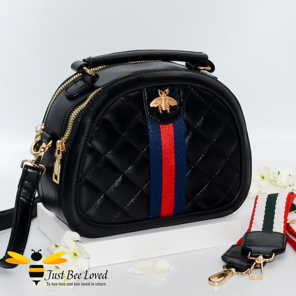 black semi-circle handbag featuring a quilted criss-cross pattern design with a honey bee embellishment on contrasting central linen band