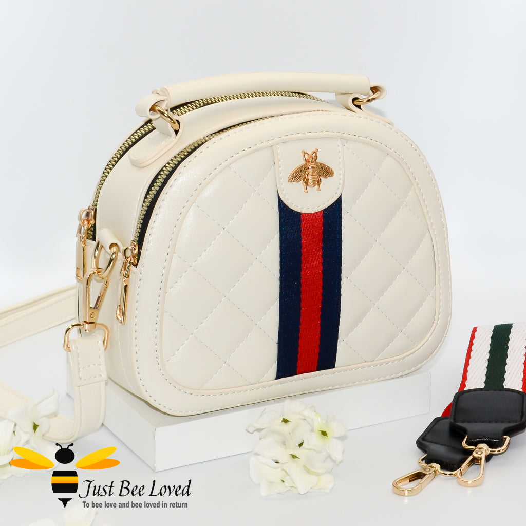 cream semi-circle handbag featuring a quilted criss-cross pattern design with a honey bee embellishment on contrasting central linen band