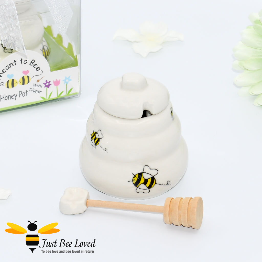 Ceramic hive shaped honey pot with dipper, decorated with bees in a gift box with 'meant to bee' text.