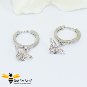 sterling silver hoop earrings inlaid with white cubic zirconia crystals with a little bee pendant