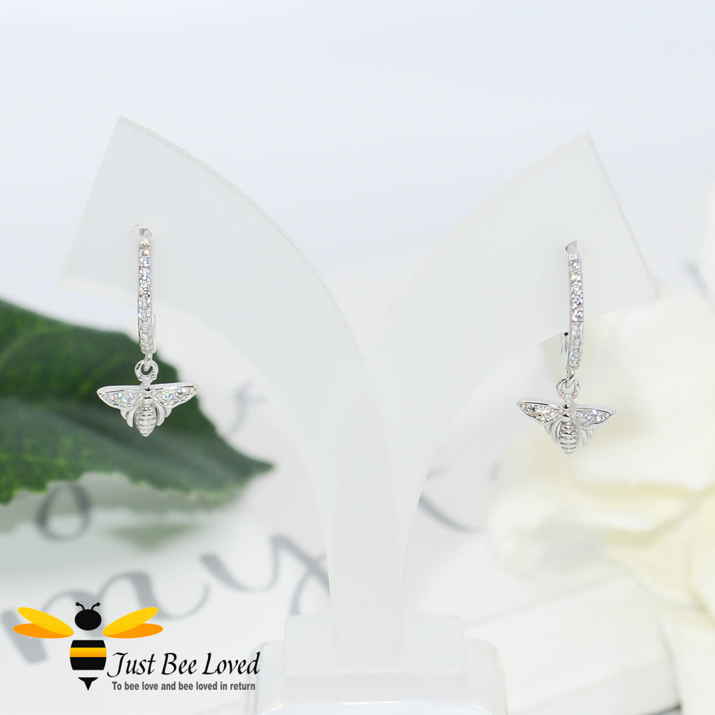 sterling silver hoop earrings inlaid with white cubic zirconia crystals with a bee pendant