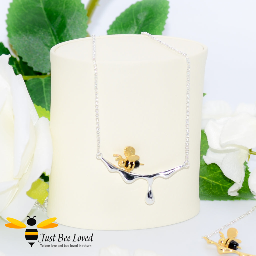 sterling silver necklace featuring an 18kt gold plated 3D honey bee resting upon silver dripping honey. 