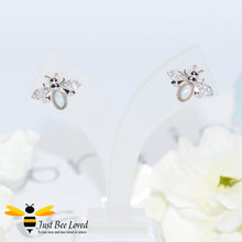 Load image into Gallery viewer, sterling silver bee stud earrings inlaid with colourful pale blue opal gemstones and white crystal encrusted wings.