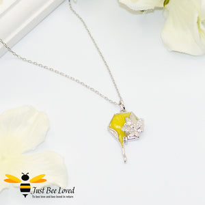 sterling silver necklace featuring a honeycomb shaped pendant with honey drip embellished with a silver bee