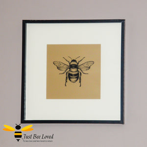 Temerity Jones Framed and mounted black bumblebee on gold backdrop wall art