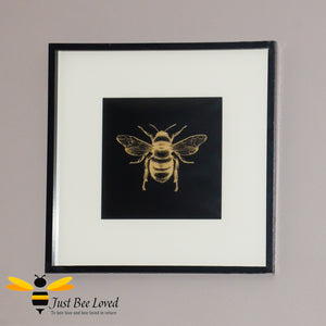 Temerity Jones Framed and mounted gold bumblebee on black backdrop wall art