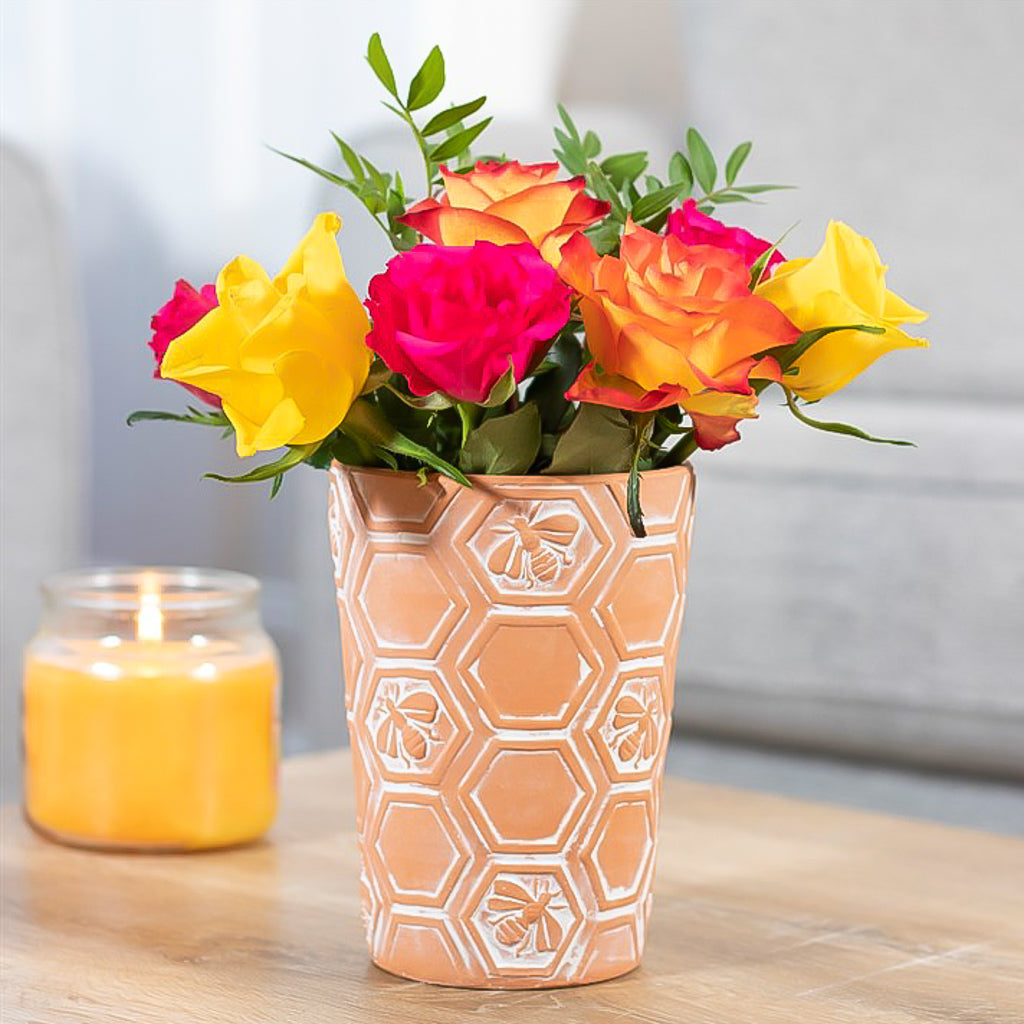 Large terracotta plant pot featuring all over embossed bees and honeycomb design.