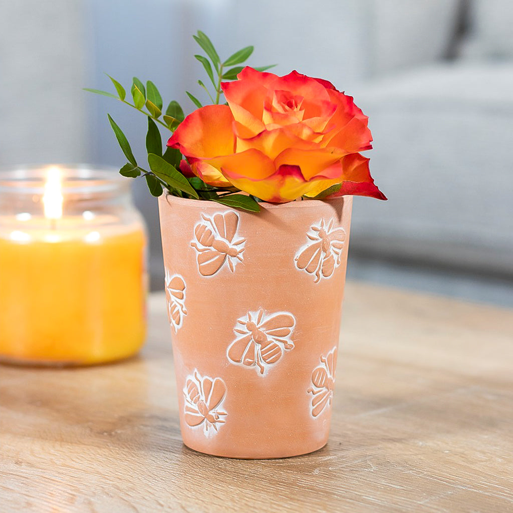 small rustic terracotta bee plant pot featuring all over embossed bees design
