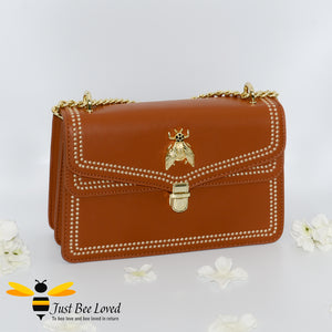 Orange vegan leather evening handbag with embroidery edged stitching and large gold bee embellishment