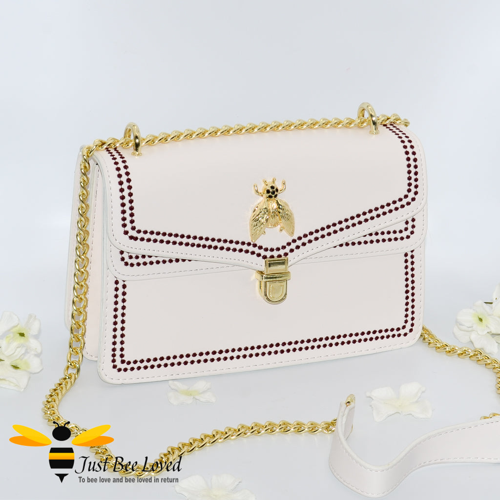 Ivory white faux leather handbag with embroidery edged stitching and gold bee embellishment