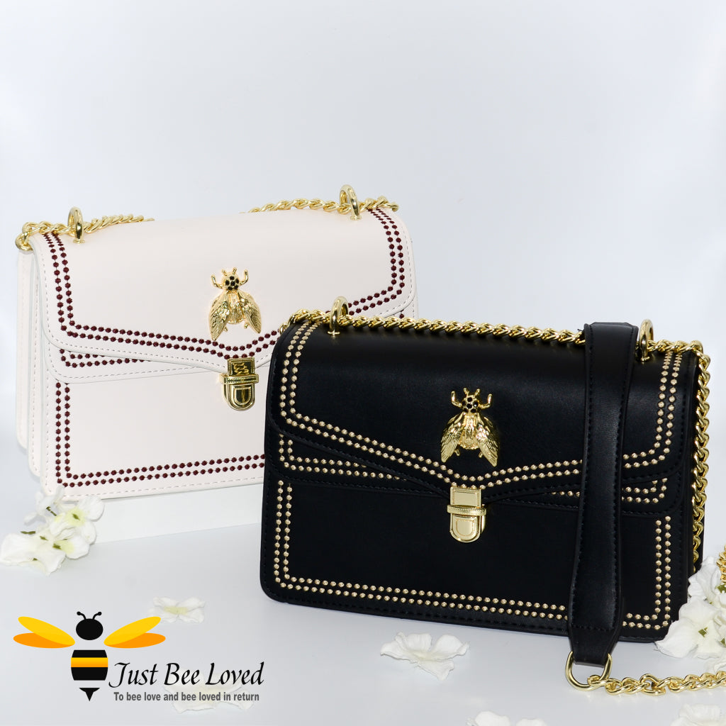 White and black faux leather handbags with embroidery edged stitching and gold bee 