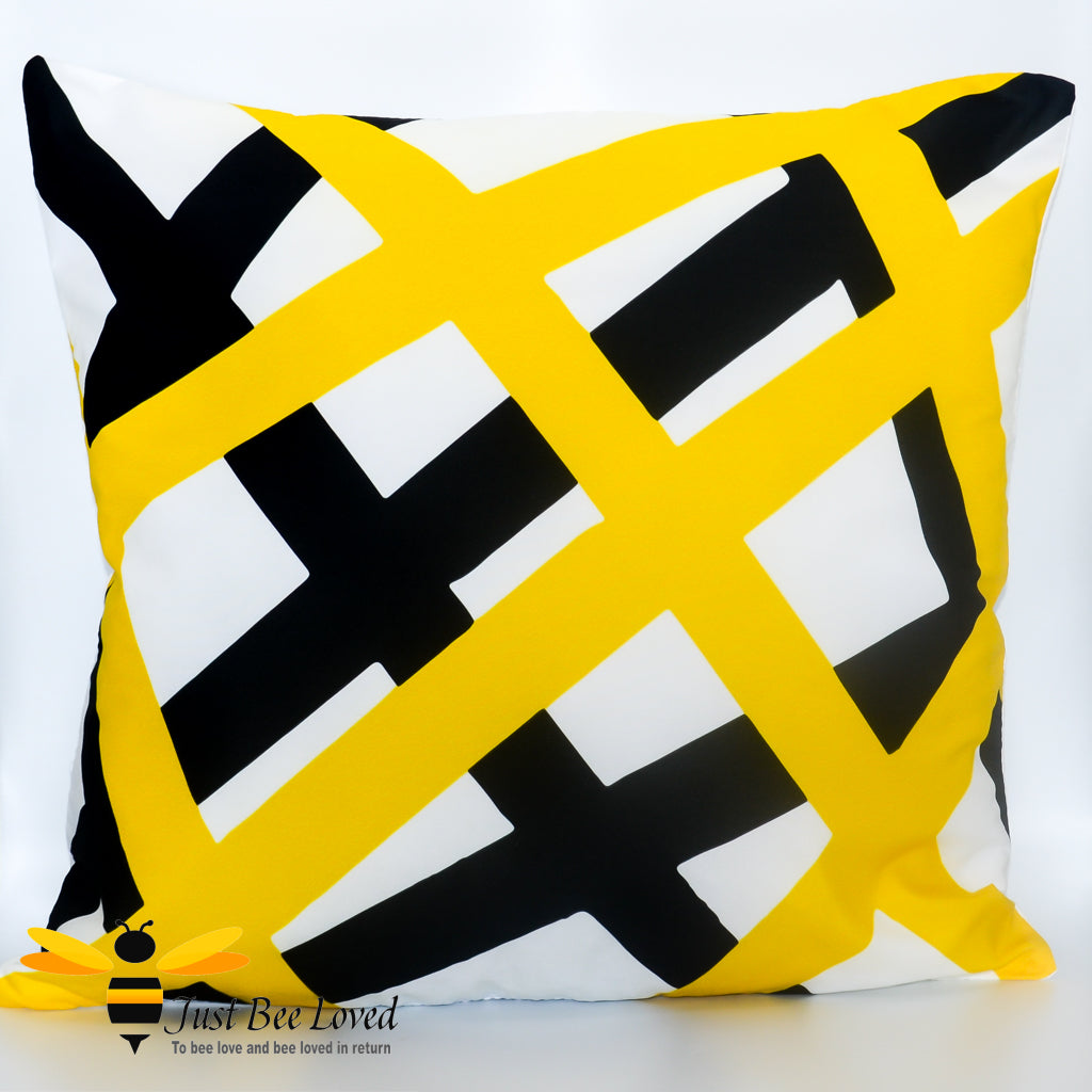 Contemporary scatter cushion featuring a black and yellow geometric criss cross design on a white background.