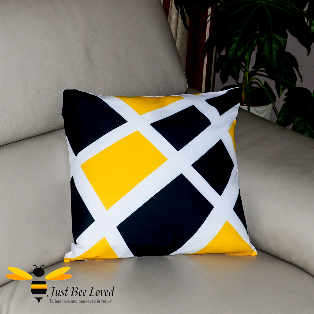 Contemporary scatter cushion featuring a black and yellow geometric design on a white background.