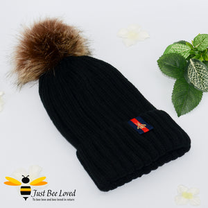 Black ribbed knit hat featuring a faux fur pom pom with embroidered bumblebee tab on rim