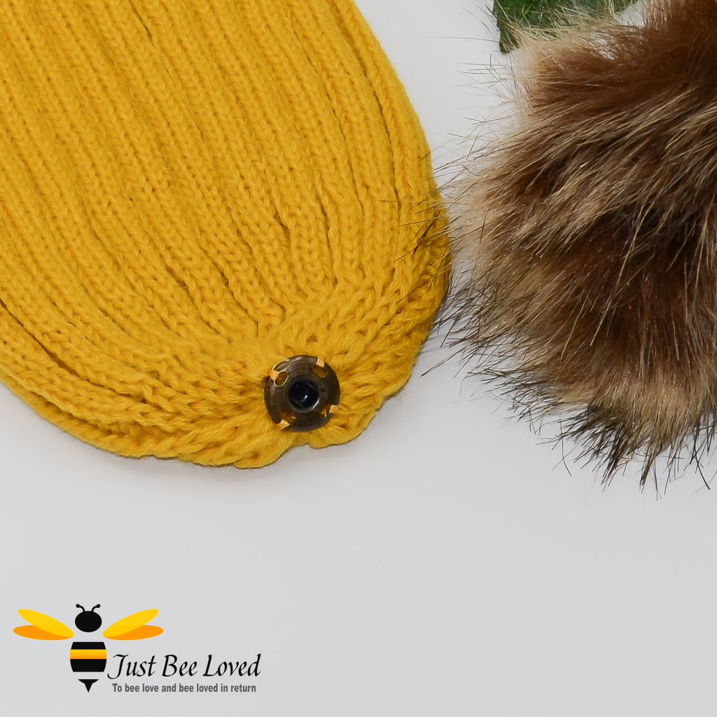 Mustard ribbed knit hat featuring a faux fur pom pom with embroidered bumblebee tab on rim