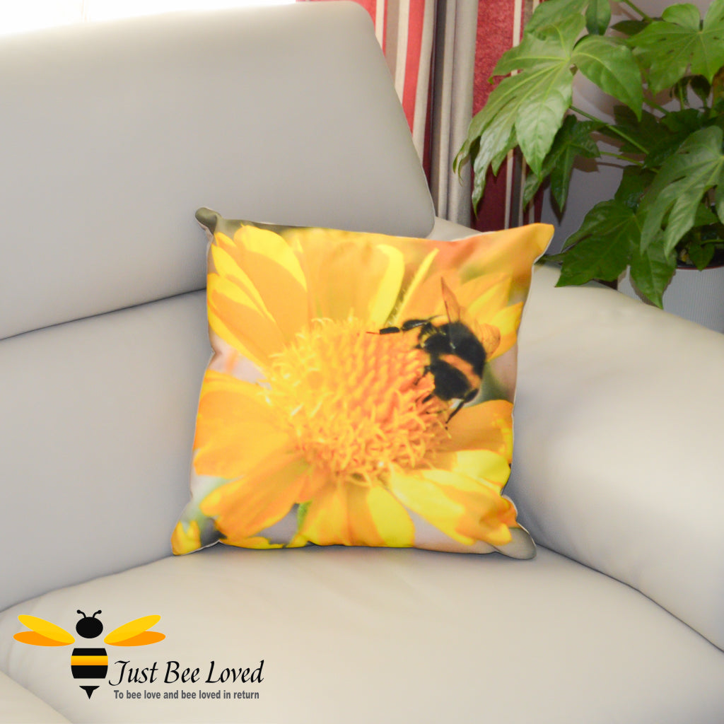 A sofa cushion featuring a photographic image of a bumblebee foraging on a bright yellow flower.
