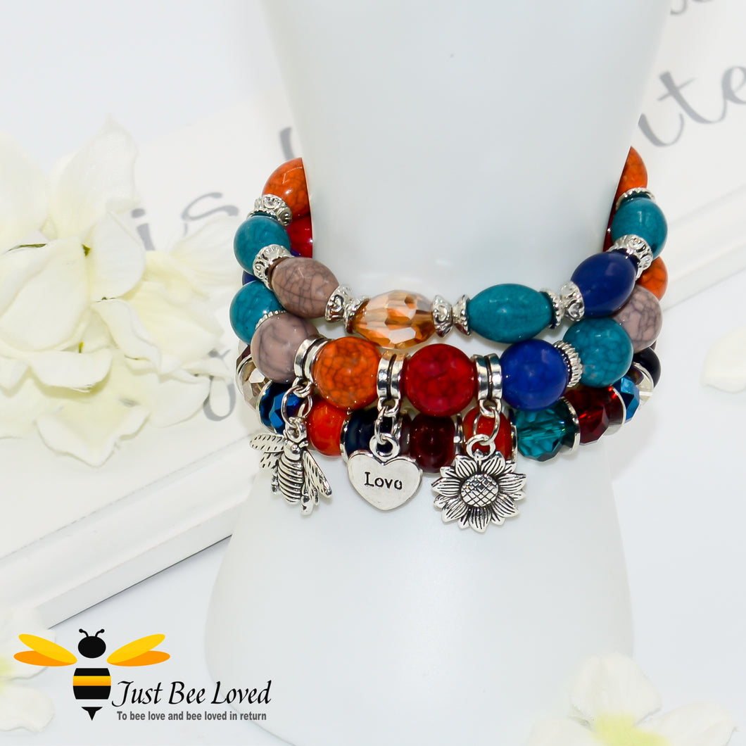 Bohemian gypsy styled 3-layer stack beaded bracelet featuring bee, love-heart and sunflower charms in multicolour blues, orange and brown