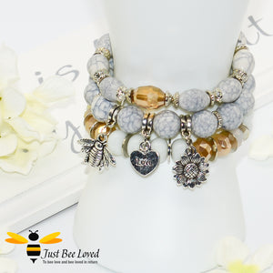 Bohemian gypsy styled 3-layer stack beaded bracelet featuring bee, love-heart and sunflower charms in white, grey and amber 