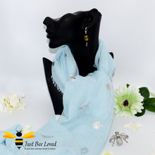 Load image into Gallery viewer, ladies scarf featuring metallic silver bumble bee print in pastel blue colour, gift boxed with crystal silver bee brooch. 