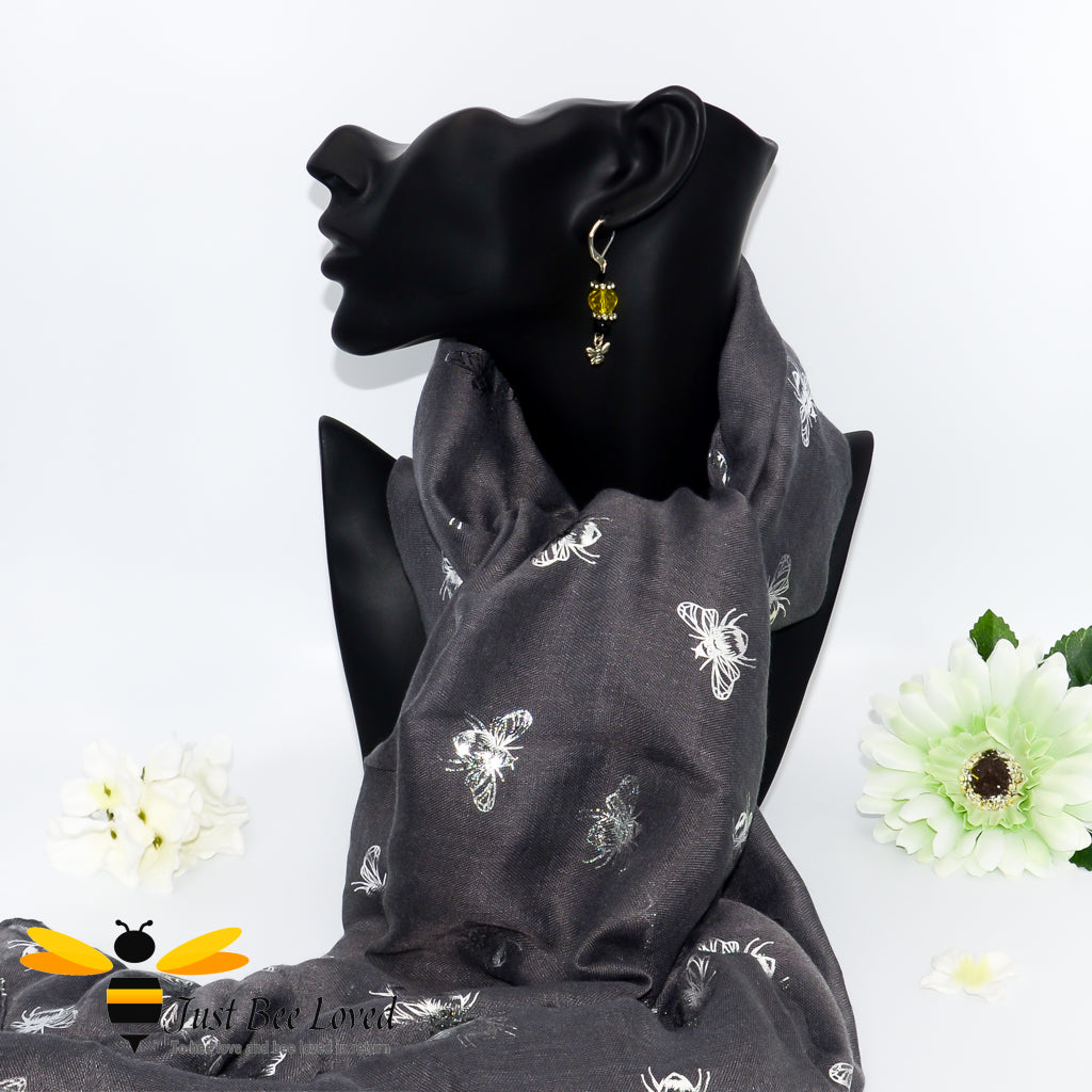 ladies scarf featuring metallic silver bumblebee print in dark grey, gift boxed with crystal bee brooch. 