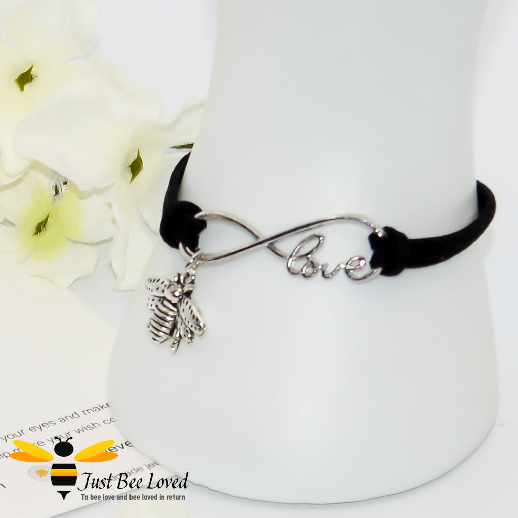 Black faux leather bracelet featuring a bee charm with love link