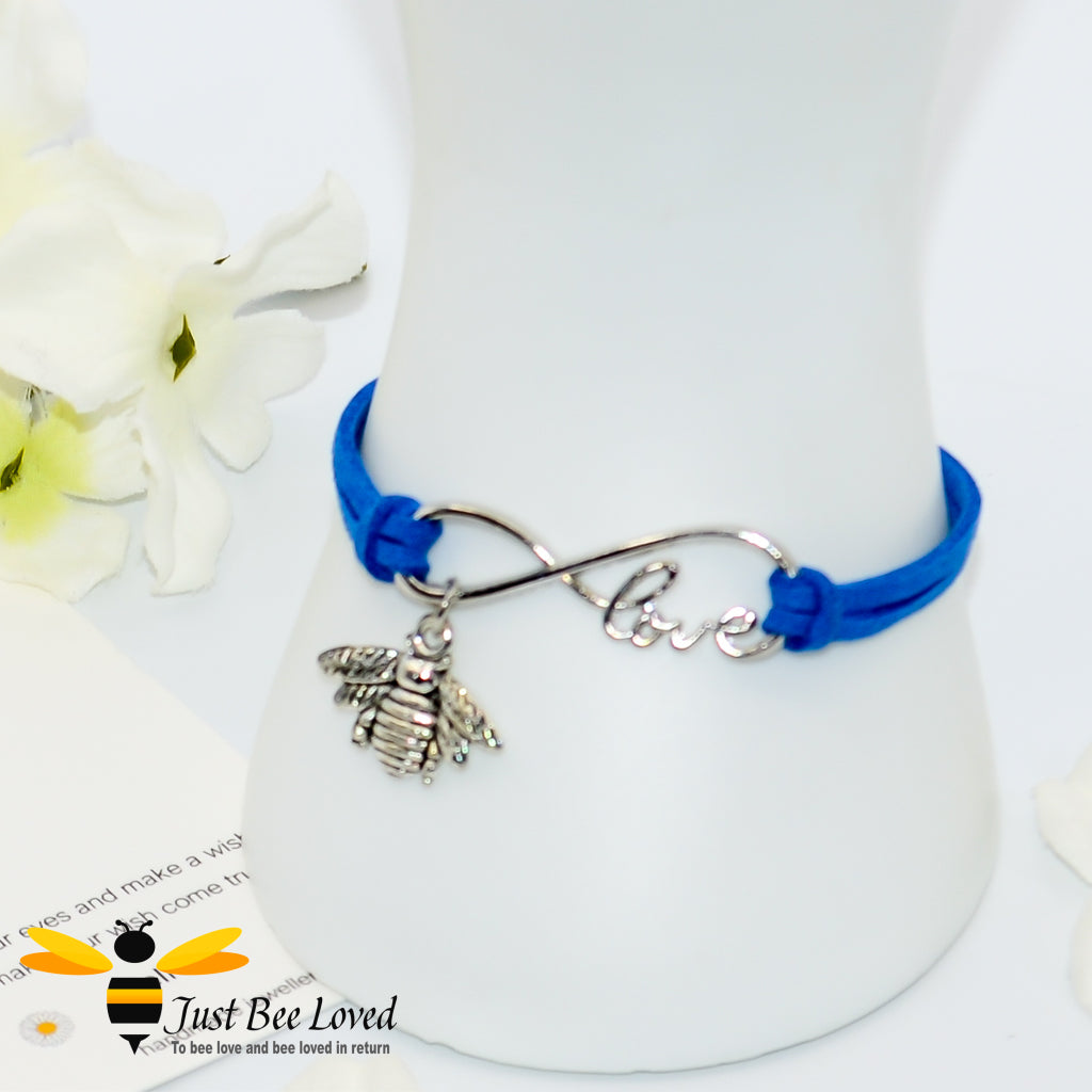 Blue faux leather bracelet featuring a Tibetan silver bee charm on a love link clasp