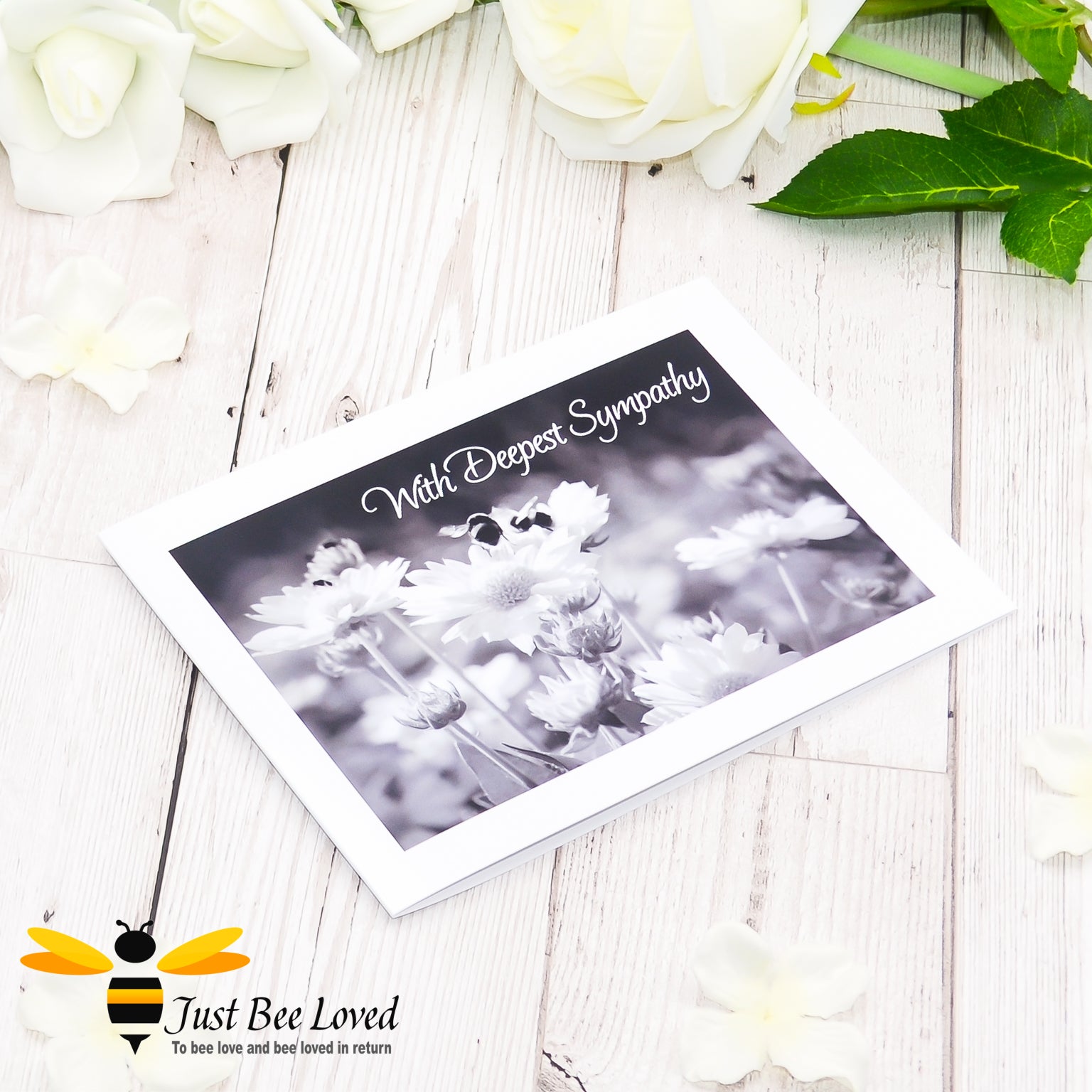 A photographic greeting card featuring a black and white image of bumblebees and daisies with the words 'With Deepest Sympathy'.