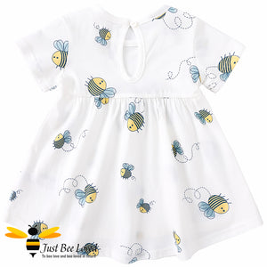 short sleeved white swing dress featuring an all over pretty little bees print decorated with a coordinating navy bow.